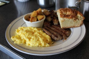 Sam's Morning Glory Diner offers Fiorella's breakfast sausage pictured here with scrambled eggs, potatoes, apple compote and a biscuit. Trivarelli, TGG.